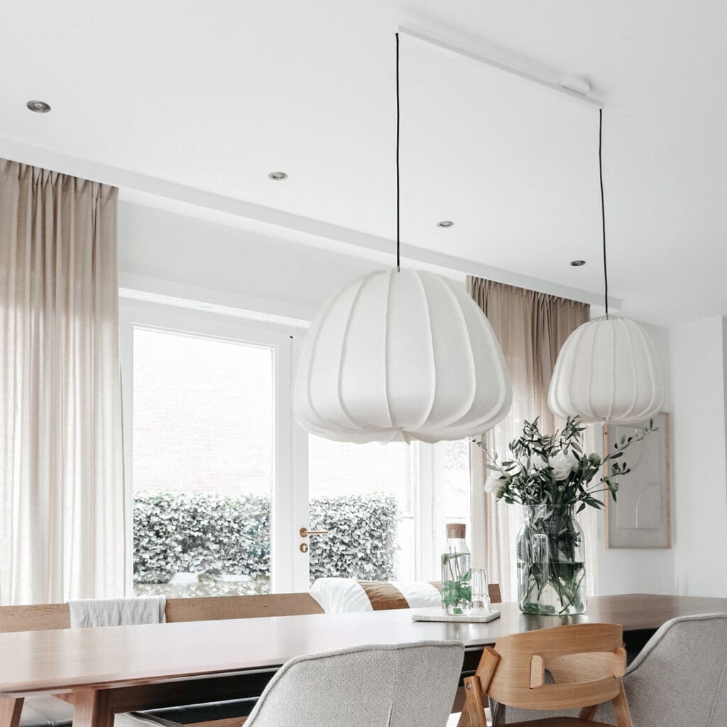 Lightswing twin white with two big pendant lights above dinging table.